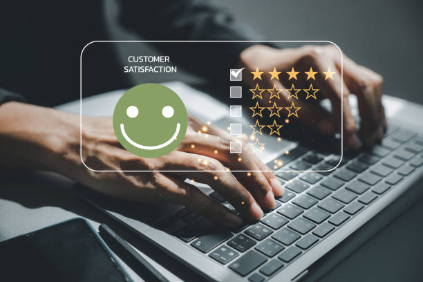 istock man's hand using a laptop with a 5-star popup for customer service satisfaction 1499947793