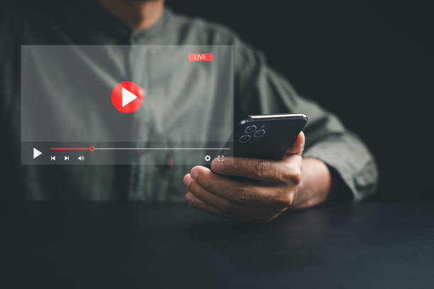 istock Man enjoying video streaming on virtual screen with a smartphone 1499947861