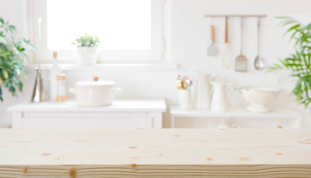 istock Blurred modern kitchen furniture interior with wooden table in front 1499948134