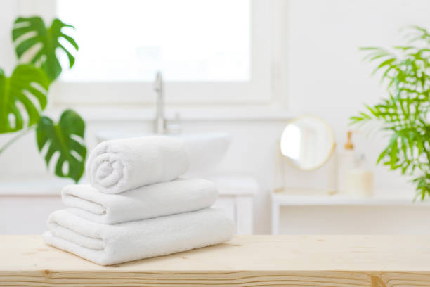 istock Spa towels on table with copy space in blurred bathroom 1499948136