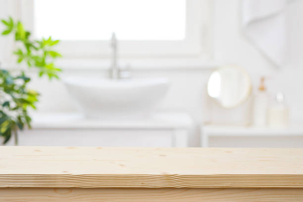 istock Blurred bathroom hand washing corner with wooden table in front 1499948142