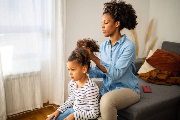 istock Mother brushing her daughters afro hair 1499949341