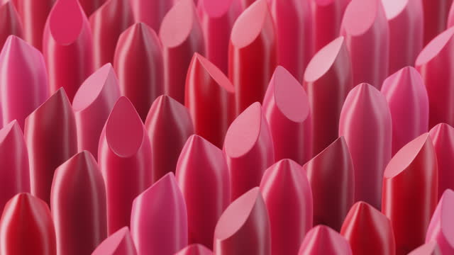 Many rotating lipstick swatches lined up in a pattern. Seamlessly looped video.