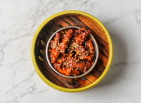Spicy steamed chicken feet with chilli served dish isolated on background top view of chinese and thai food
