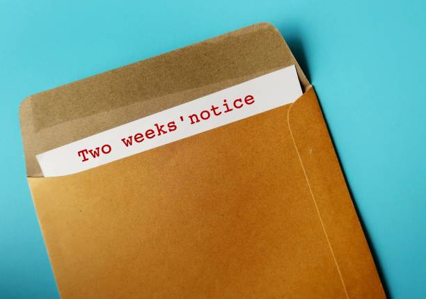 istock Office envelope and document with words - Two weeks' notice, means employee courtesy to give employer time to prepare for resignation and hiring someone else 1499951511