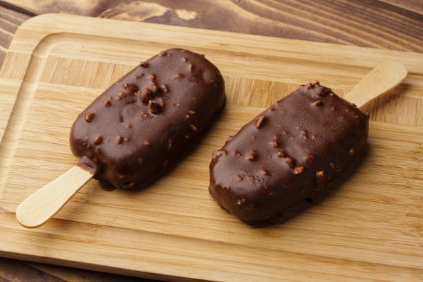 istock Chocolate cake pops ice creams on wooden board close up 1499954565