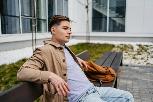 istock Young Man Sitting On The City Bench 1499957061