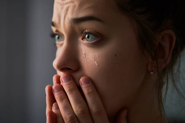 istock Sad desperate crying female with folded hands and tears eyes during trouble, life difficulties, loss and emotional problems 1499958031