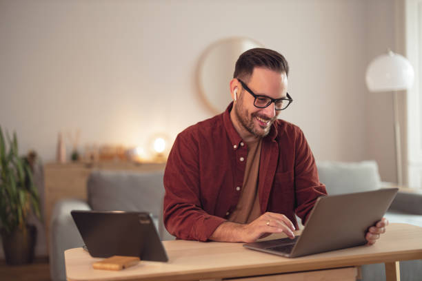 istock Positive businessman working alone, at his home office, using a laptop. 1499959225