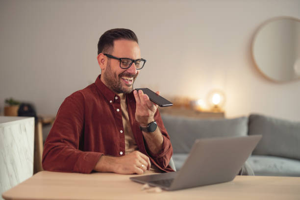istock Man taking a break from online work, holding mobile phone, making a phone call. 1499959652