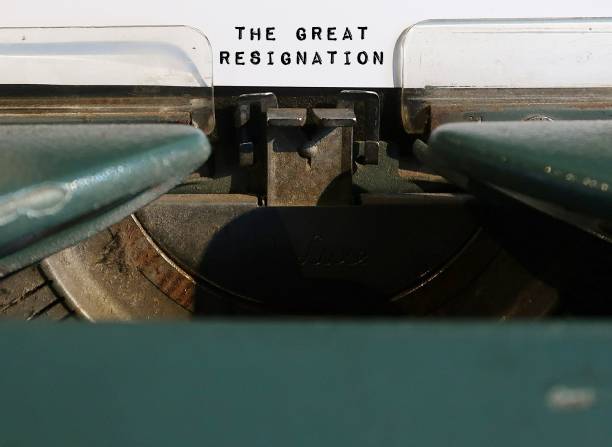 istock Old classic vintage typewriter with typed text THE GREAT RESIGNATION- blur copy space foreground,mass voluntary exodus from the workforce - ongoing trend of millions workers quitting their jobs 1499960711