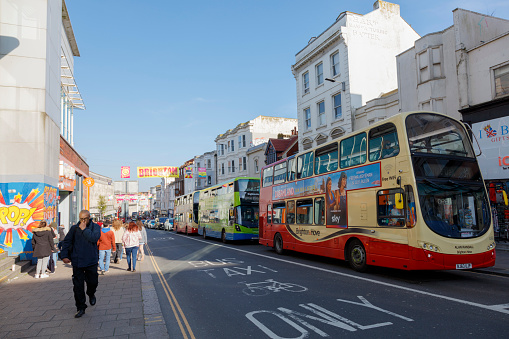 Brighton, United Kingdom - April 29, 2023: Locals and tourists are walking and shopping on the street enjoying the beautiful day and laid-back lifestyle in Brighton.
