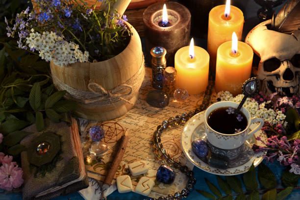 istock Mortar with healing herbs, runes and candles on altar table. Occult, esoteric and fortune telling still life. Mystic background with vintage objects 1499961623