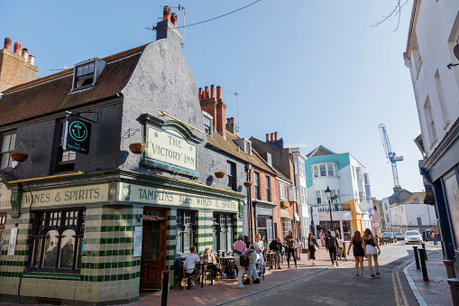 Brighton, United Kingdom - April 29, 2023: Locals and tourists are walking and shopping on the street enjoying the beautiful day and laid-back lifestyle in Brighton.