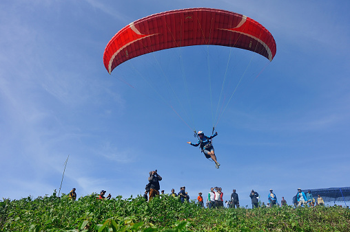 Bantul, Yogyakarta, Indonesia, March 1, 2014 : Athletes doing skydiving exercises at Parangtritis Beach, Bantul, Yogyakarta. They are preparing to take part in the parachuting competition which will be held next year.