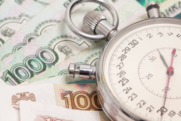 istock Time is money concept, Stopwatch on Russian ruble banknotes. 1499962950