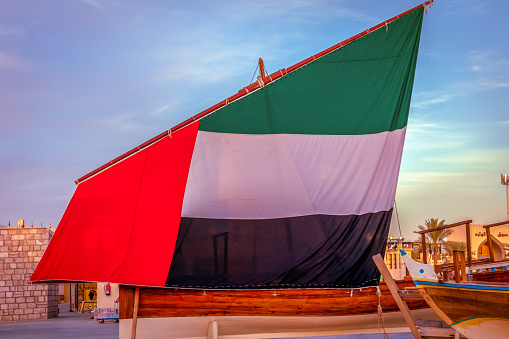 National United Arab Emirates flag on a yacht, red, green, white and black colors of UAE flag