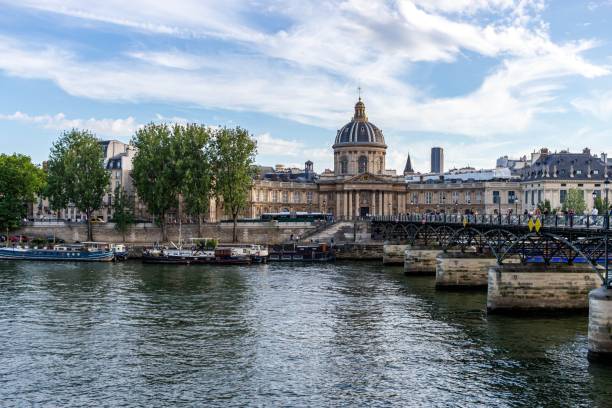 istock a river with boats and people in it, in paris 1499963118