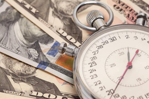 istock Stopwatch with dollar banknotes. Time is money concept 1499963704