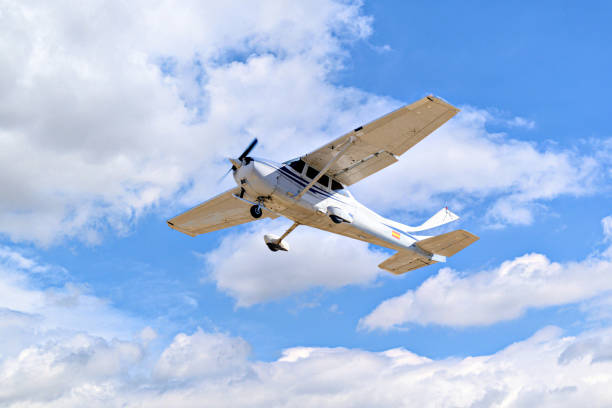 istock Light aircraft flying over blue sky 1499966371