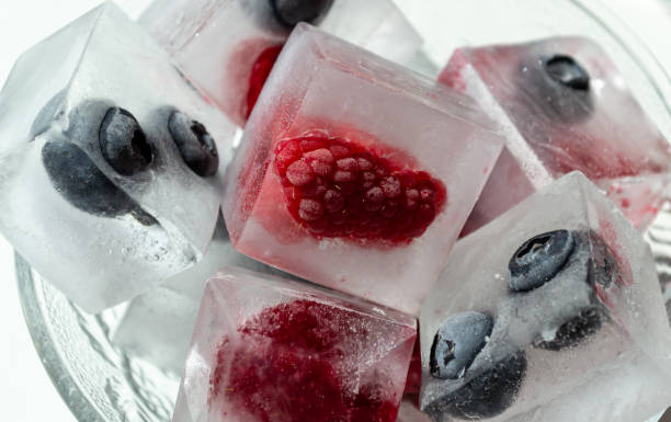 istock Blueberries and raspberries in ice cubes 1499966624