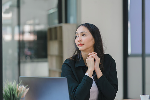 Young Indian Accountant Woman in casuals working on financial analysis documents with a tense expression in the office. Business finance and accounting concepts