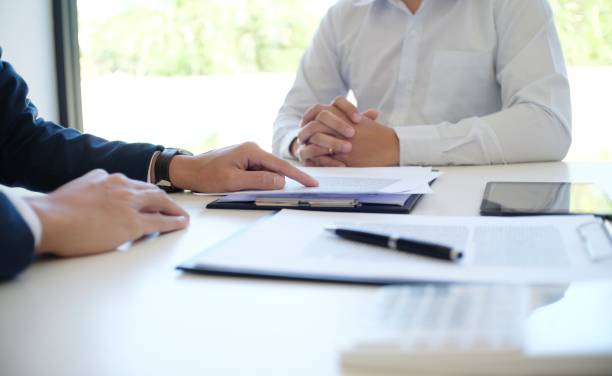 istock Sales manager giving advice application form document, considering mortgage loan offer for car and house insurance. 1499967822
