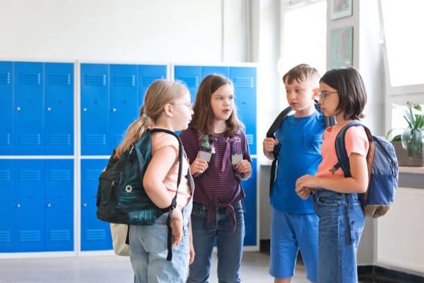 istock School children talking in the school corridor 1499972497