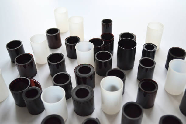 istock Boxes with lids and rolls of 35mm negative film on white background. Film negative digitization. 1499972649
