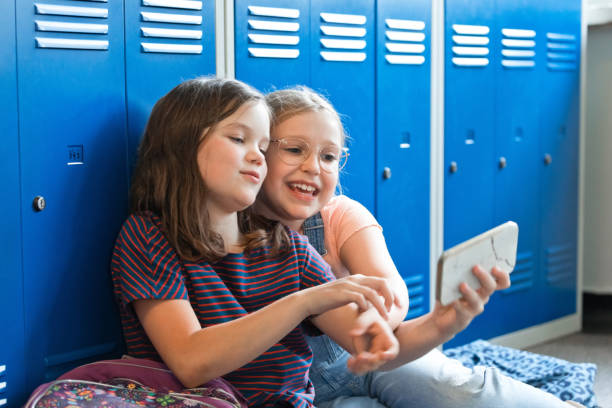 istock School girls sitting in the school corridor 1499972747