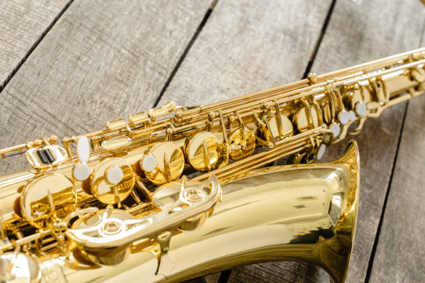 istock Beautiful golden saxophone on wooden background 1499972752