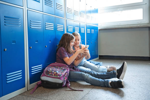 istock School girls sitting in the school corridor 1499972794