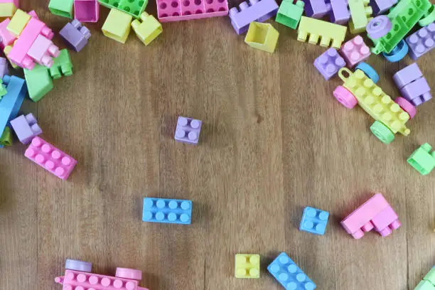 Messy legos on wooden floor, kids toy concept