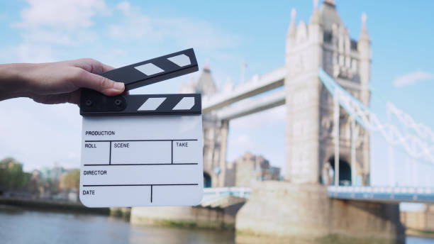 Hand is holding clapper board or movie slate with Tower Bridge background. Hand is holding clapper board or movie slate with Tower Bridge background. tower bridge london england bridge europe stock pictures, royalty-free photos & images