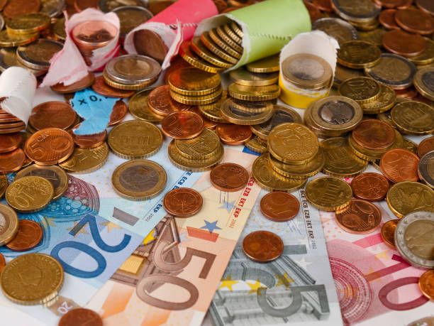 istock euro notes and all sorts of coins are densely distributed on a surface 1499976829