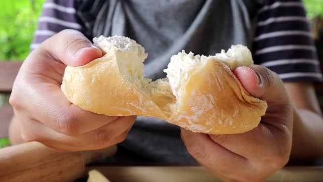 Female baker's hands dividing slices. Daily Fresh bakery slowly baked