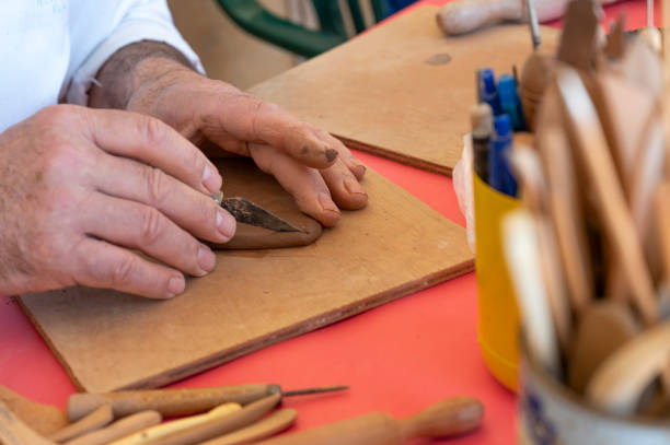istock Close-up of a craftsman's hands working with clay 1499980552