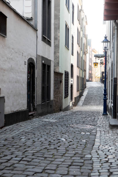 istock Buildings in an empty cobblestone street 1499981711