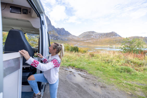 istock Road trip- woman stepping out a camper van 1499986335