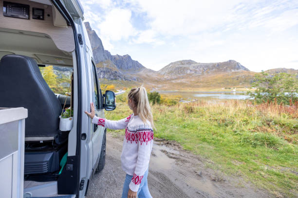 istock Road trip- woman stepping out a camper van 1499986342