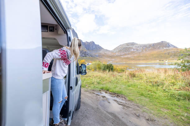 istock Road trip- woman stepping out a camper van 1499986380