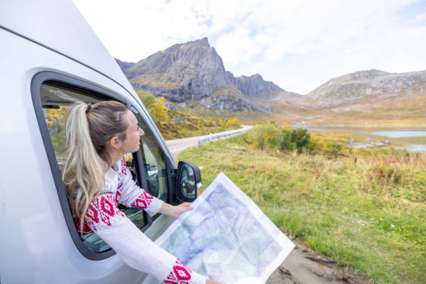 istock Road trip- woman in a camper van looking at road map 1499986965