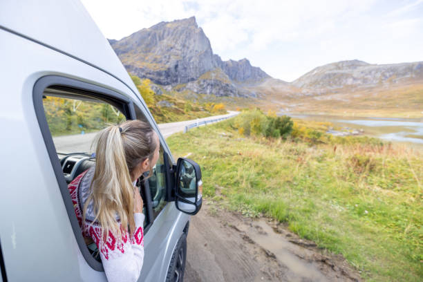 istock Road trip- woman in a camper van looking at road 1499987538