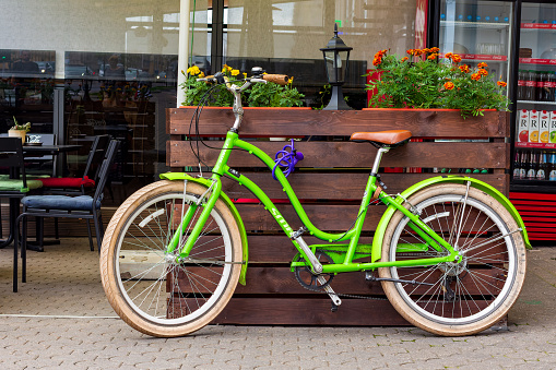 Minsk, Belarus - August 8, 2017: A light green Smart bicycle outside a city café
