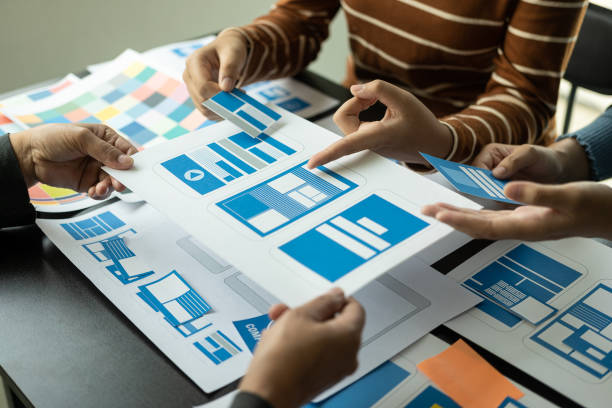 istock UI/UX web design teams are working together to develop mobile application websites too. Website development concept with UX UI display system on the front of smartphone 1499988940