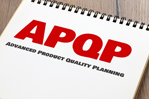 APQP Advanced Product Quality Planning words in an office notebook.