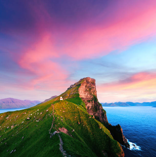 Incredible sunset landscape with Kallur lighthouse Incredible sunset landscape with Kallur lighthouse on green hills of Kalsoy island, Faroe islands, Denmark green valley denmark stock pictures, royalty-free photos & images