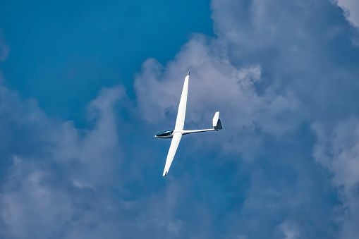 Glider plane flying in the clouds