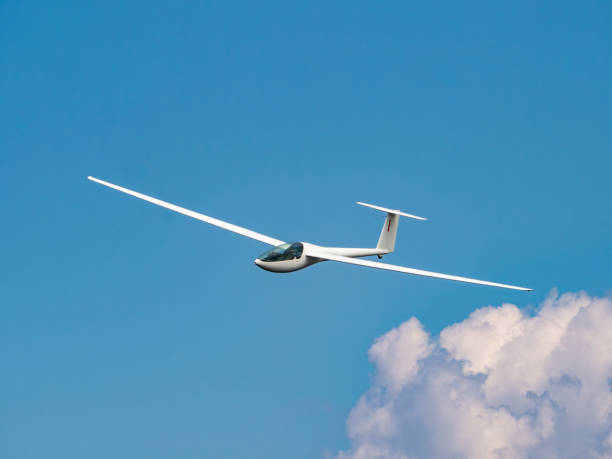 istock Glider plane flying in the clouds 1500001524