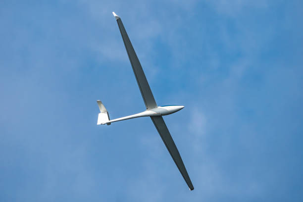 istock Glider plane flying in the clouds 1500001525
